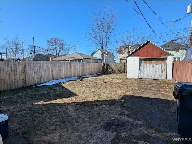 view of yard with a fenced backyard, a storage shed, and an outdoor structure