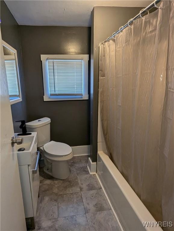 bathroom featuring vanity, toilet, baseboards, and shower / tub combo with curtain