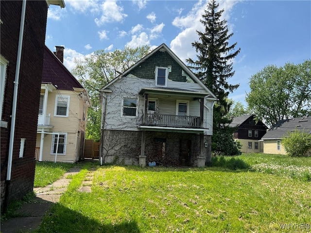 rear view of house with a lawn