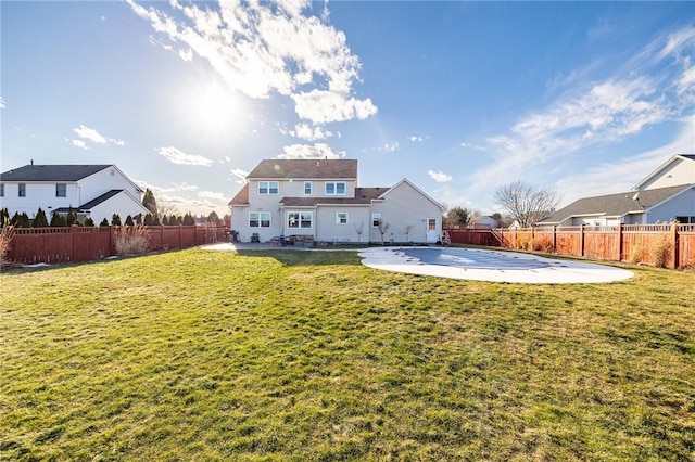 back of property featuring a yard, a patio area, and a fenced backyard