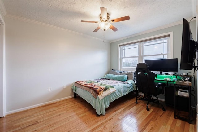 bedroom with crown molding, light wood-type flooring, and a textured ceiling