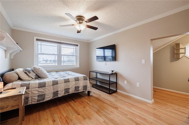 bedroom with a textured ceiling, light wood-style flooring, baseboards, and ornamental molding