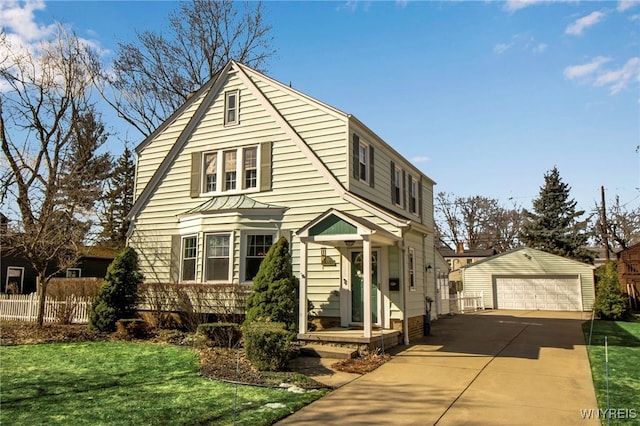 view of front of home with a garage, an outdoor structure, a front lawn, and fence