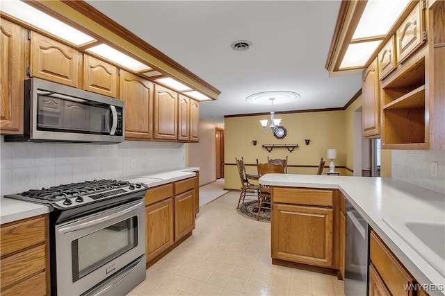 kitchen featuring visible vents, appliances with stainless steel finishes, light countertops, and a peninsula