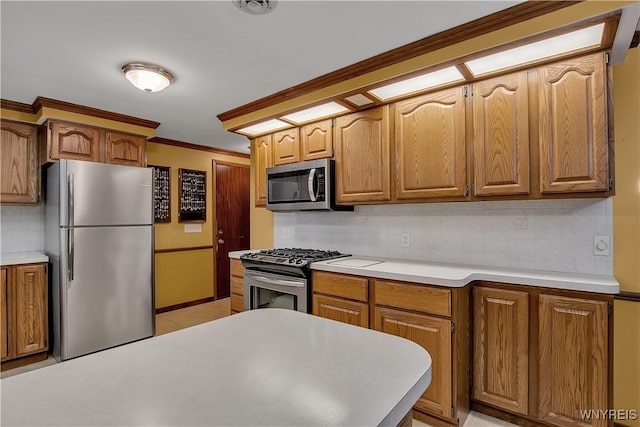 kitchen featuring crown molding, light countertops, decorative backsplash, brown cabinetry, and stainless steel appliances