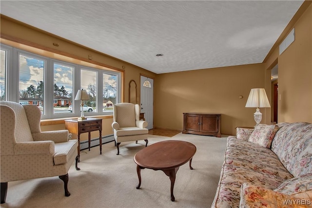 living room with light colored carpet, a textured ceiling, and a baseboard heating unit