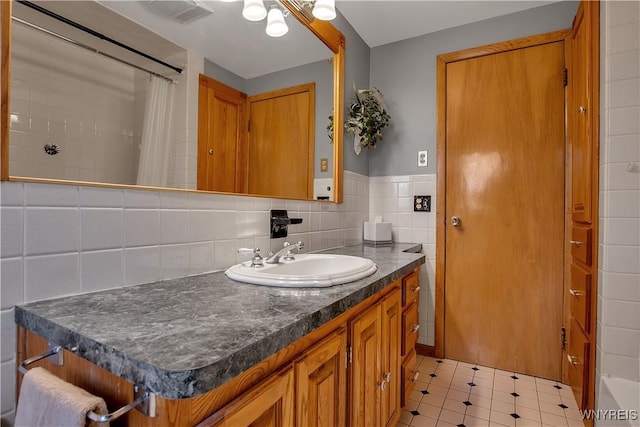 bathroom featuring visible vents, tile walls, vanity, and a shower with shower curtain