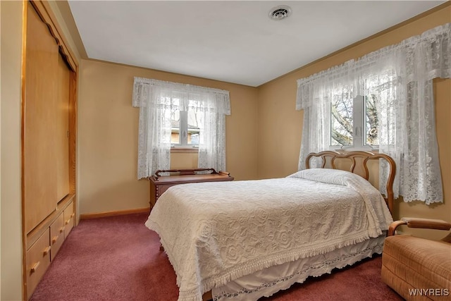 bedroom featuring carpet, visible vents, and baseboards