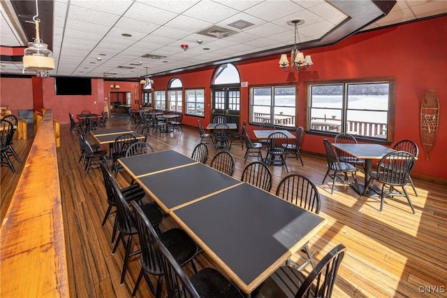 recreation room featuring visible vents, a paneled ceiling, baseboards, and wood finished floors