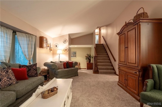 living area with lofted ceiling, stairway, and carpet floors