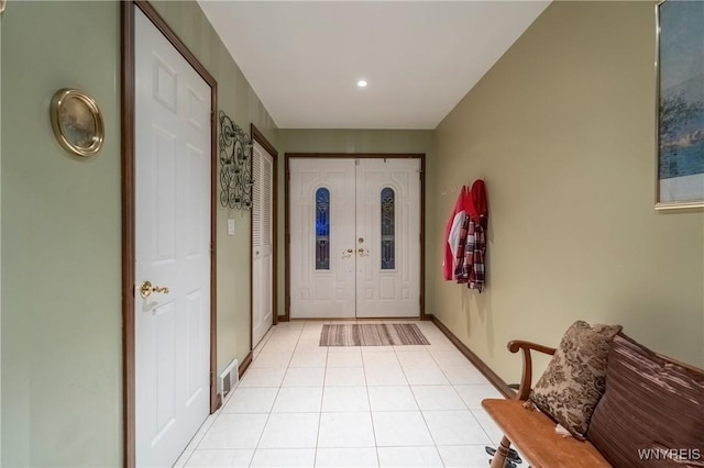 foyer with light tile patterned floors, baseboards, and recessed lighting