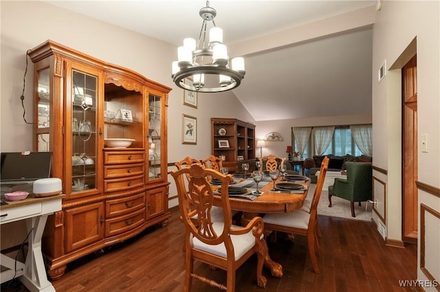 dining space with dark wood finished floors, a notable chandelier, visible vents, and lofted ceiling