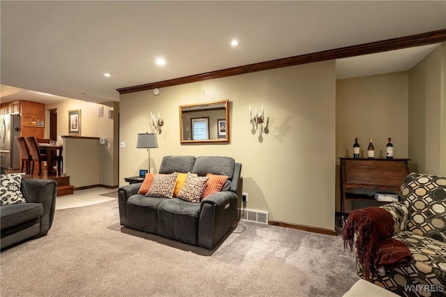 living area featuring visible vents, baseboards, light colored carpet, and crown molding