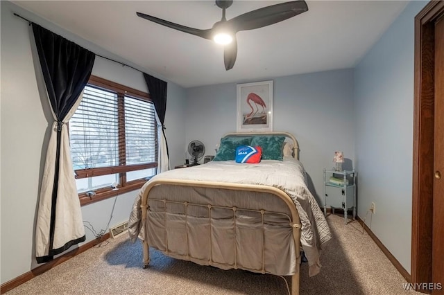 bedroom featuring light carpet, ceiling fan, and baseboards