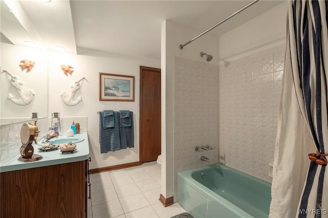 bathroom with vanity, baseboards, shower / bath combo with shower curtain, tile patterned floors, and toilet