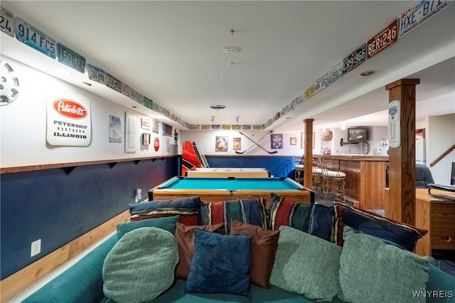 game room featuring wainscoting, a bar, billiards, and ornate columns