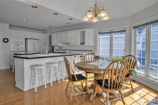 dining room featuring a notable chandelier, recessed lighting, and light wood-style floors