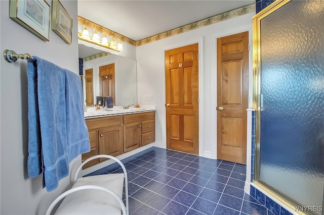 bathroom with tile patterned flooring, a shower stall, double vanity, and a sink