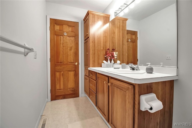 bathroom featuring visible vents, vanity, and tile patterned flooring