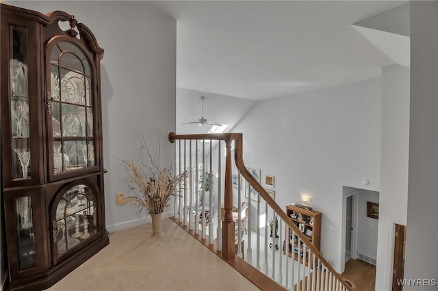 hall featuring baseboards, an upstairs landing, high vaulted ceiling, and carpet floors