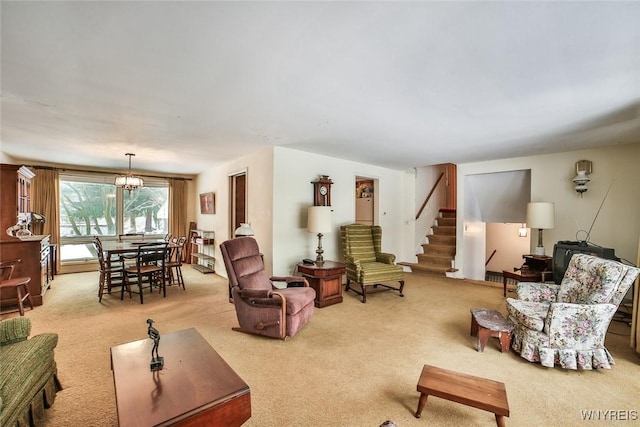 living room featuring light carpet, stairway, and a chandelier