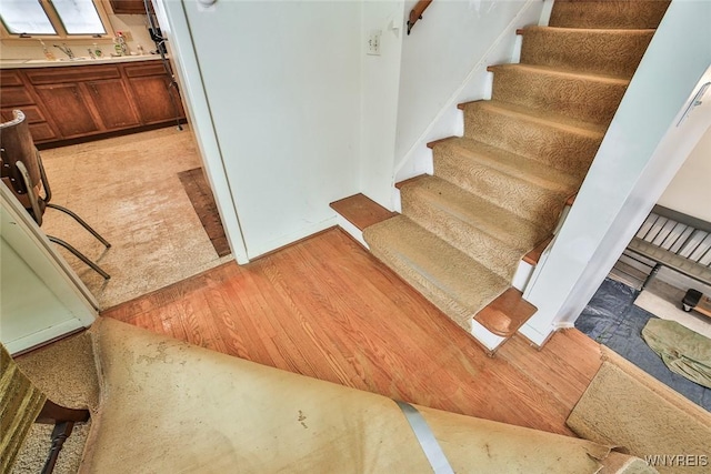 staircase featuring wood finished floors