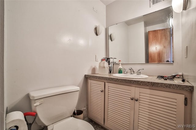 bathroom with toilet and vanity