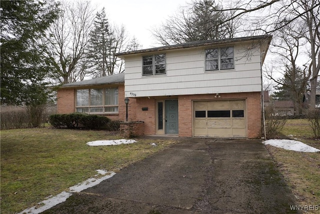 tri-level home with brick siding, an attached garage, aphalt driveway, and a front lawn