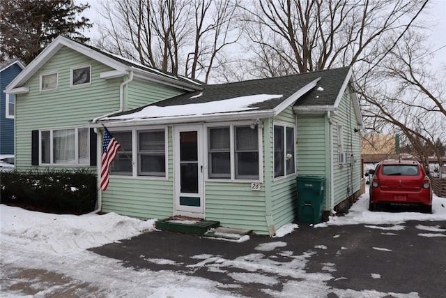 view of front of home with entry steps and roof with shingles