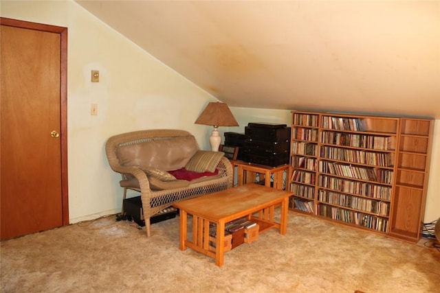 sitting room with lofted ceiling and carpet