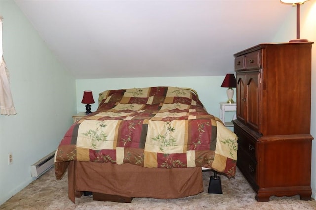 bedroom with vaulted ceiling, carpet floors, and a baseboard radiator