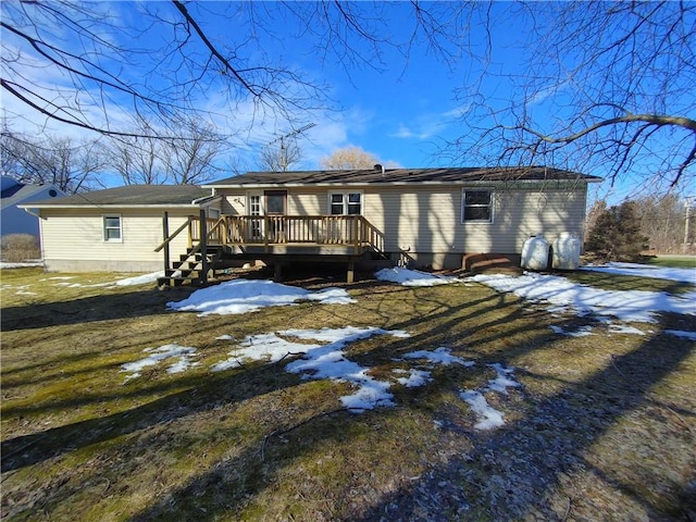 snow covered rear of property featuring a wooden deck