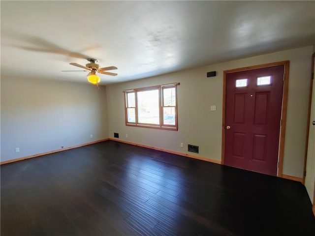 foyer featuring dark wood finished floors, baseboards, visible vents, and a ceiling fan