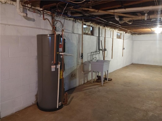 unfinished below grade area featuring gas water heater and a sink