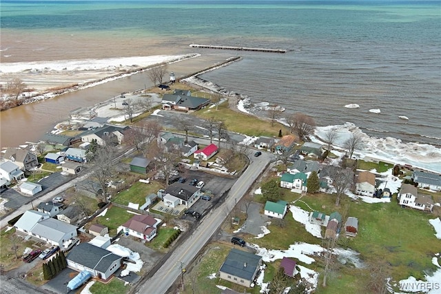 drone / aerial view featuring a residential view and a water view