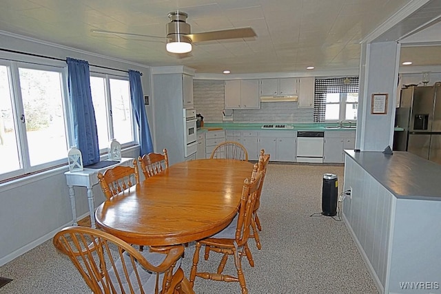 dining area with baseboards and ceiling fan