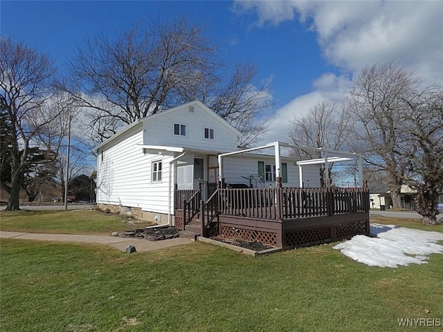 back of property with a deck and a yard