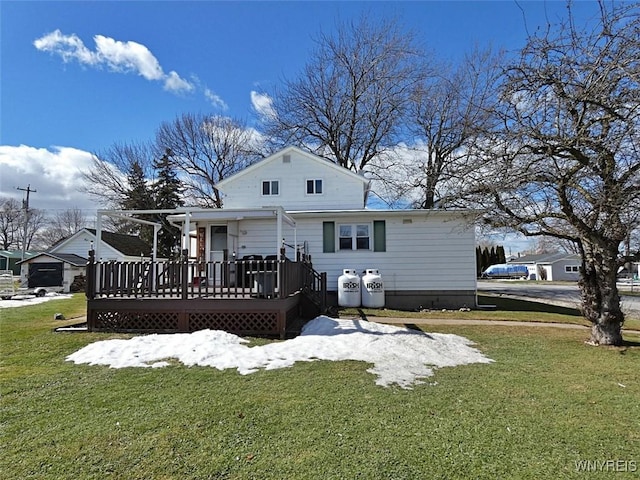 rear view of property featuring a yard and a deck