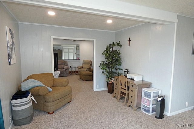 living area with crown molding, carpet, and baseboards