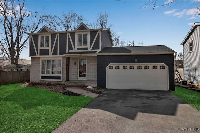 tudor house featuring a front lawn, aphalt driveway, fence, an attached garage, and brick siding