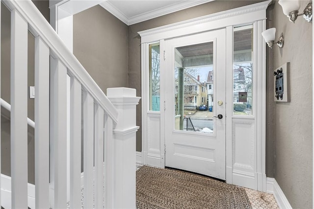 doorway to outside featuring crown molding, stairway, plenty of natural light, and baseboards