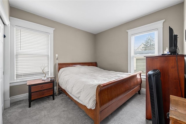 carpeted bedroom with baseboards