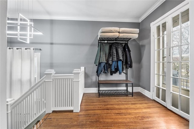 mudroom with ornamental molding, baseboards, and wood finished floors