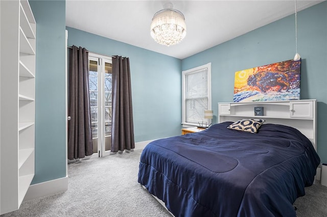 bedroom featuring baseboards, a chandelier, and carpet flooring