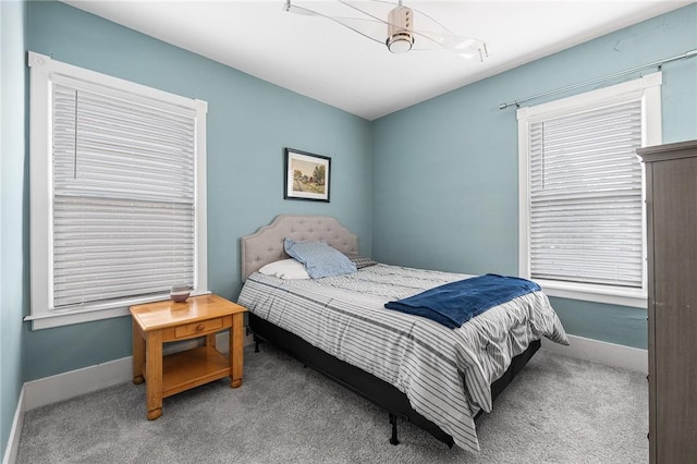 carpeted bedroom with baseboards