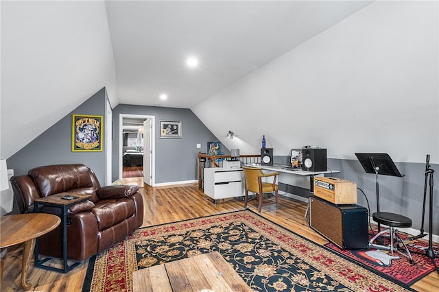 office featuring vaulted ceiling, wood finished floors, and baseboards