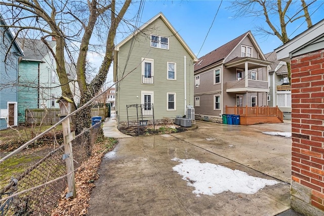 rear view of house with central AC unit and a patio area