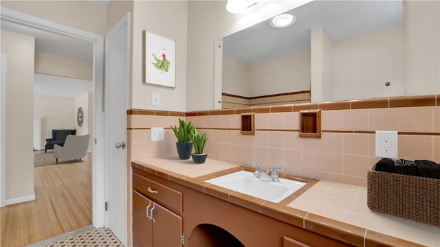 bathroom with decorative backsplash, vanity, and wood finished floors