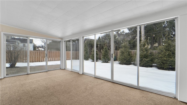 unfurnished sunroom featuring vaulted ceiling and a wealth of natural light