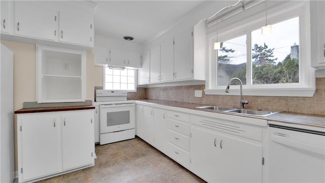 kitchen with white appliances, a sink, light countertops, white cabinets, and backsplash